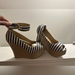Striped denim sandals with wedge heel and ankle strap.